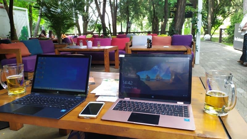 What is a Digital Nomad? - Two laptops, mobile phone and beers on a table in an outdoor restaurant